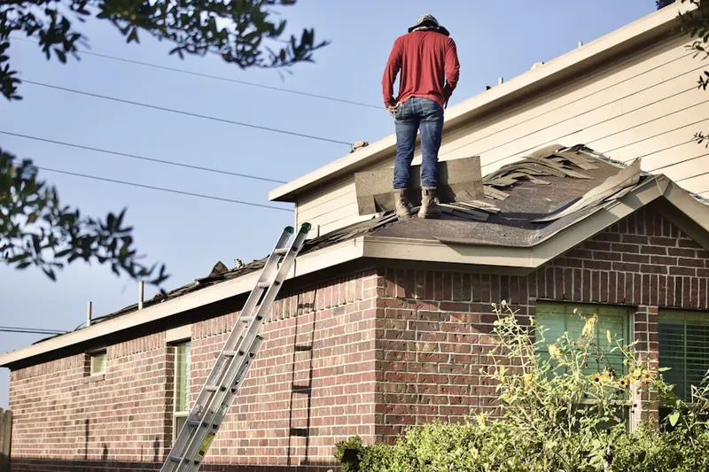 Professional roofer working on a residential roof in Amity